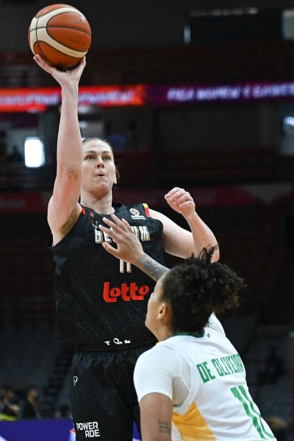 Belgium's Emma Meesseman (L) shoots under pressure of Brazil's Emanuely Oliveira during the FIBA Women's Basketball World Cup 2026 qualifying tournament match between Brazil and Belgium in Wuhan, in China's central Hubei province, on March 11, 2026. (Photo by CN-STR / AFP) / China OUT