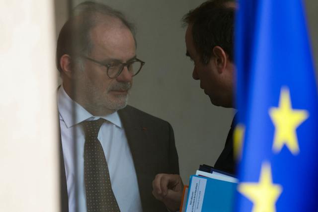 Secretary General of the French Presidency Emmanuel Moulin (L) listens to France's Prime Minister Sebastien Lecornu (R) as they leave after the weekly cabinet meeting at the presidential Elysee Palace in Paris on March 11, 2026. (Photo by Thomas SAMSON / AFP)