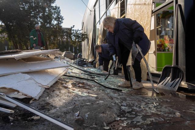 People clear debris at the site of a recent Ukrainian missile strike in Bryansk on March 11, 2026. A Ukrainian missile strike on the western Russian city of Bryansk killed seven people and wounded 42, according to the region's governor's latest update. (Photo by Andrey BORODULIN / AFP)