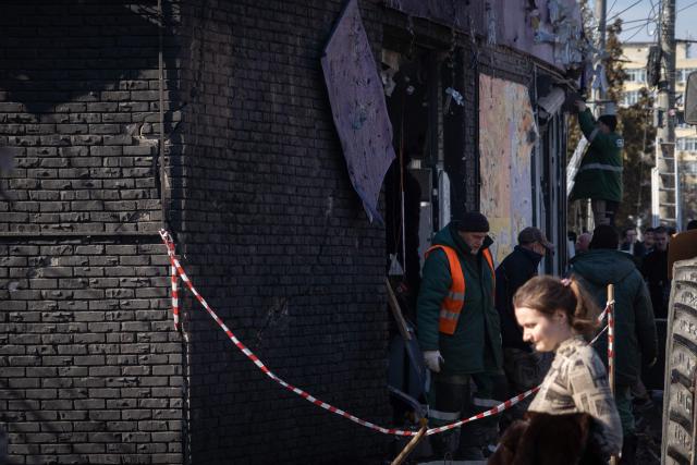 People clear debris at the site of a recent Ukrainian missile strike in Bryansk on March 11, 2026. A Ukrainian missile strike on the western Russian city of Bryansk killed seven people and wounded 42, according to the region's governor's latest update. (Photo by Andrey BORODULIN / AFP)
