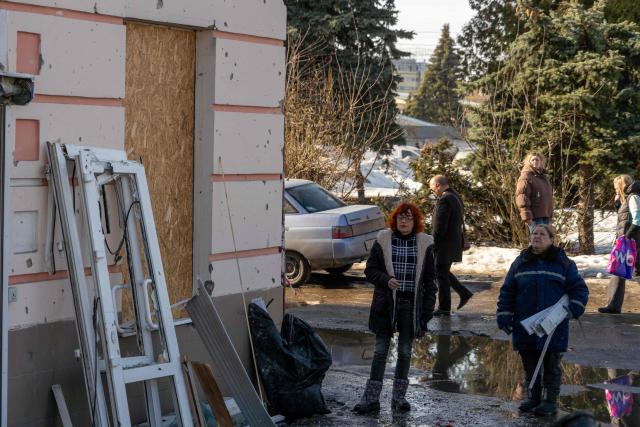 People clear debris at the site of a recent Ukrainian missile strike in Bryansk on March 11, 2026. A Ukrainian missile strike on the western Russian city of Bryansk killed seven people and wounded 42, according to the region's governor's latest update. (Photo by Andrey BORODULIN / AFP)