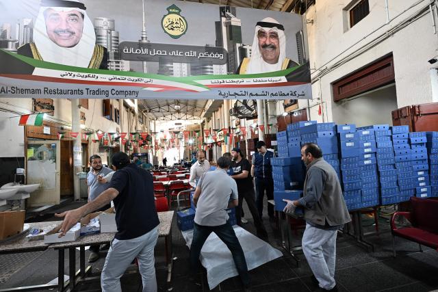 Workers prepare the "iftar" fast-breaking meal for fasting Muslims during the Muslim holy month of Ramadan, at a restaurant in Kuwait City on March 11, 2026. The oil-rich Gulf has borne the brunt of Iran's attacks in response to US-Israeli strikes that sparked the Middle East war, with Tehran targeting US assets but also civilian infrastructure, including energy facilities and airports. (Photo by YASSER AL-ZAYYAT / AFP)