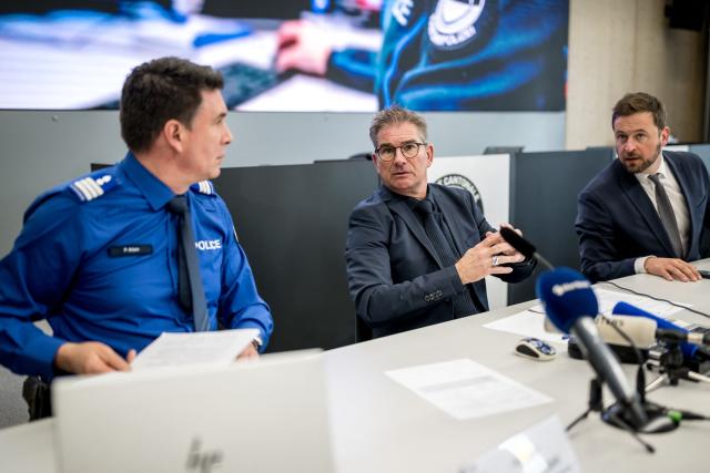 (From L) Head of the police of the Canton of Fribourg Philippe Allain, Fribourg's attorney general Raphael Bourquin and member of the Government of the Canton of Fribourg in charge of security Romain Collaud give a press conference on March 11, 2026 in Fribourg, western Switzerland, one day after a bus caught fire in Kerzers killing at least six people and injuring five others in what police said may have been a deliberate act. (Photo by Fabrice COFFRINI / AFP)