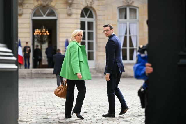 President of Rassemblement National parliamentary group Marine Le Pen (L) and French far-right Rassemblement National RN party's President Jordan Bardella arrive at the Hotel Matignon to attend a meeting of party leaders on the conflict in Iran, hosted by French Prime Minister, in Paris on March 11, 2026. (Photo by Bertrand GUAY / AFP)