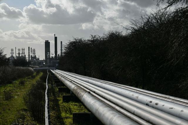 This general view shows pipework between the Humber Refinery (behind), operated by Phillips 66, and the Humber estuary near South Killingholme, north-east England on March 11, 2026. World oil prices surged more than five percent on March 11 as the Middle East war disrupted crude exports. (Photo by Oli SCARFF / AFP)