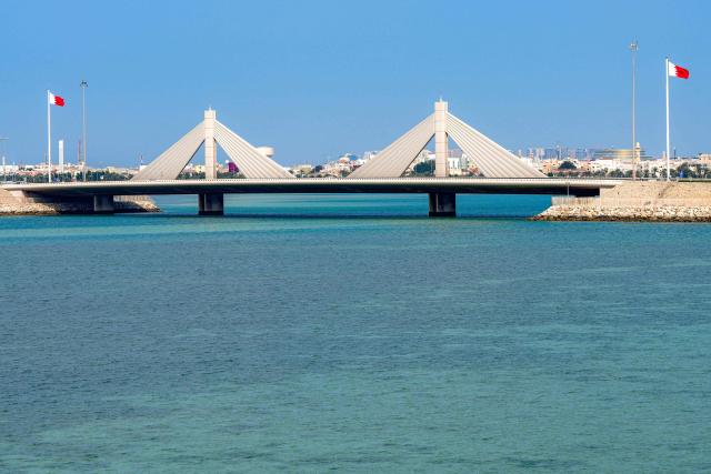 Vehicles move along the Muharraq Bridge in Bahrain's capital Manama on March 11, 2026. Iran's Revolutionary Guards said on March 11 that they had targeted several US bases in Kuwait and Bahrain during the war with the United States and Israel. (Photo by AFP) / 
