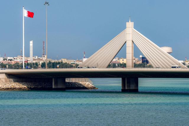 Vehicles move along the Muharraq Bridge in Bahrain's capital Manama on March 11, 2026. Iran's Revolutionary Guards said on March 11 that they had targeted several US bases in Kuwait and Bahrain during the war with the United States and Israel. (Photo by AFP) / 