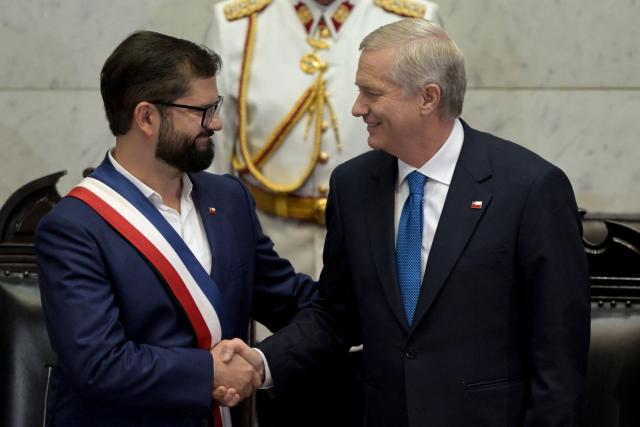 Chile’s outgoing President Gabriel Boric (L), wearing the presidential sash, shakes hands with Chile’s new President Jose Antonio Kast at the National Congress in Valparaiso, Chile, on March 11, 2026. Chile's most right-wing president in over three decades, Jose Antonio Kast, takes office on March 11, 2026, on a promise to tackle surging rates of violent crime and carry out mass migrant deportations. (Photo by RODRIGO ARANGUA / AFP)