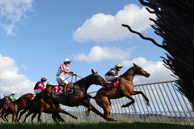 Winner Final Orders ridden by Jockey Conor Stone-Walsh (R), leads Latenightpass ridden by jockey Gina Andrews (C) and second-placed Favori De Champdou ridden by jockey Jack Kennedy to win the Glenfarclas Cross Country Chase horse race on the second day of the Cheltenham Festival at Cheltenham Racecourse, in Cheltenham, western England on March 11, 2026. (Photo by Adrian DENNIS / AFP)