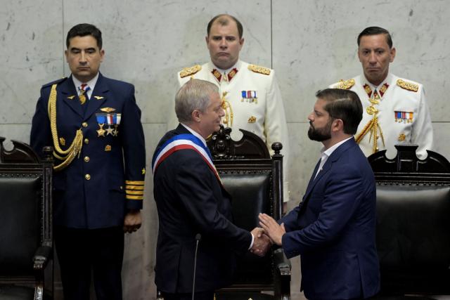 Chile’s new President Jose Antonio Kast (R), wearing the presidential sash, shakes hands with Chile’s outgoing President Gabriel Boric at the National Congress in Valparaiso, Chile, on March 11, 2026. Chile's most right-wing president in over three decades, Jose Antonio Kast, takes office on March 11, 2026, on a promise to tackle surging rates of violent crime and carry out mass migrant deportations. (Photo by RODRIGO ARANGUA / AFP)