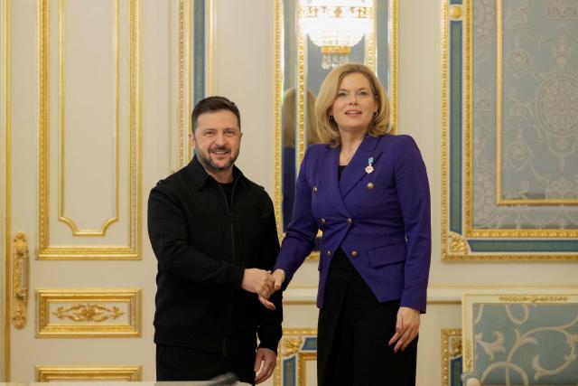 Ukraine's President Volodymyr Zelensky (L) shakes hands with the President of the Bundestag Julia Kloeckner (R) before a press conference in Kyiv on March 11, 2026, amid the Russian invasion of Ukraine. (Photo by Tetiana DZHAFAROVA / AFP)