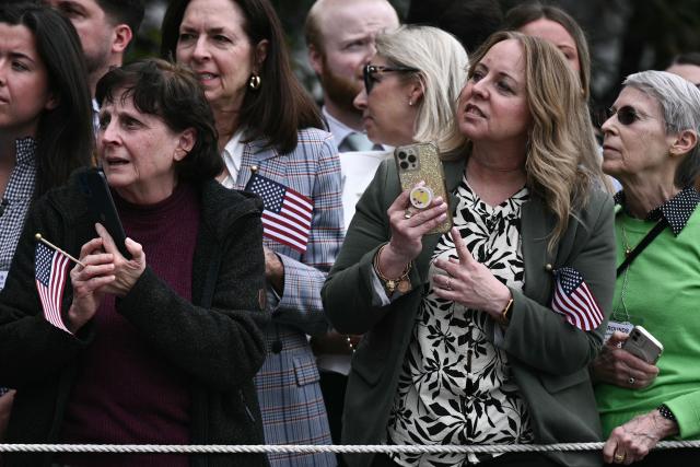 Guests on the South Lawn of the White House wait for US President Donald Trump to walk to Marine One in Washington, DC, on March 11, 2026. Trump will be making multiple stops in Kentucky and Ohio including Thermo Fisher Scientific and Verst Logistics. (Photo by Brendan SMIALOWSKI / AFP)