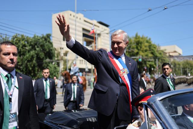 Chile's new President Jose Antonio Kast waves from the presidential convertible car after his inauguration ceremony in Valparaiso, Chile, on March 11, 2026. Chile's most right-wing president in over three decades, Jose Antonio Kast, takes office on March 11, 2026, on a promise to tackle surging rates of violent crime and carry out mass migrant deportations. (Photo by Javier TORRES / AFP)