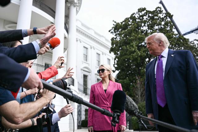 US President Donald Trump speaks to reporters alongside White House Press Secretary Karoline Leavitt before departing from the South Lawn of the White House in Washington, DC, on March 11, 2026. Trump will be making multiple stops in Kentucky and Ohio including Thermo Fisher Scientific and Verst Logistics. (Photo by Brendan SMIALOWSKI / AFP)