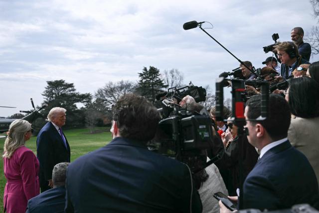 US President Donald Trump speaks to reporters alongside White House Press Secretary Karoline Leavitt before departing from the South Lawn of the White House in Washington, DC, on March 11, 2026. Trump will be making multiple stops in Kentucky and Ohio including Thermo Fisher Scientific and Verst Logistics. (Photo by Brendan SMIALOWSKI / AFP)