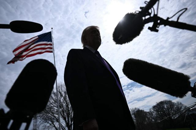 US President Donald Trump speaks to reporters before boarding Marine One as he departs from the South Lawn of the White House in Washington, DC, on March 11, 2026. Trump will be making multiple stops in Kentucky and Ohio including Thermo Fisher Scientific and Verst Logistics. (Photo by Brendan SMIALOWSKI / AFP)