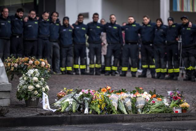 Firefighters attend a memorial ceremony in Kerzers, western Switzerland on March 11, 2026, the day after six people were killed in a bus fire which was seemingly started by a disturbed man on board who set himself alight. (Photo by Fabrice COFFRINI / AFP)