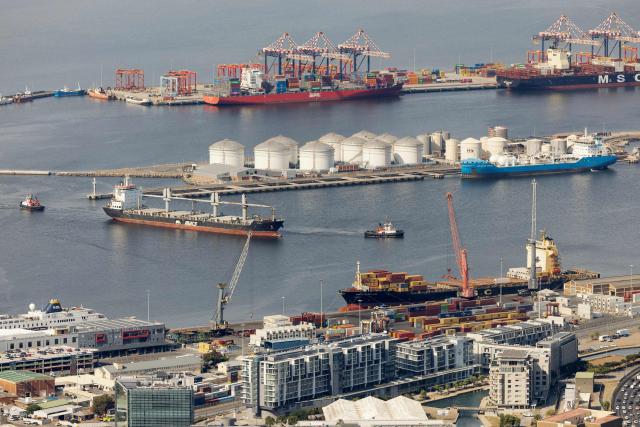 A tugboat navigates a cargo vessel in the harbour in Cape Town on March 11, 2026. (Photo by GIANLUIGI GUERCIA / AFP)
