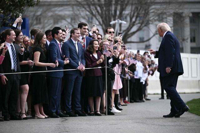 US President Donald Trump speaks with guests before boarding Marine One as he departs from the South Lawn of the White House in Washington, DC, on March 11, 2026. Trump will be making multiple stops in Kentucky and Ohio including Thermo Fisher Scientific and Verst Logistics. (Photo by Brendan SMIALOWSKI / AFP)