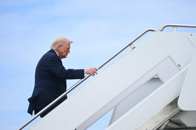 US President Donald Trump boards Air Force One at Joint Base Andrews in Maryland on March 11, 2026. Trump will be making multiple stops in Kentucky and Ohio including Thermo Fisher Scientific and Verst Logistics. (Photo by Jim WATSON / AFP)