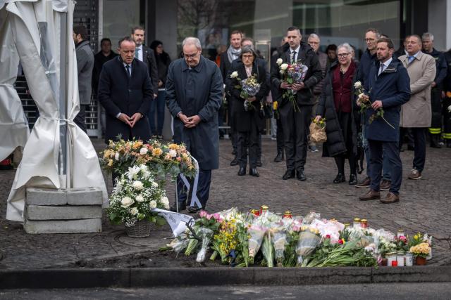 Switzerland's President Guy Parmelin (2nd L) pays his respect during a memorial ceremony in Kerzers, western Switzerland on March 11, 2026, the day after six people were killed in a bus fire which was seemingly started by a disturbed man on board who set himself alight. (Photo by Fabrice COFFRINI / AFP)