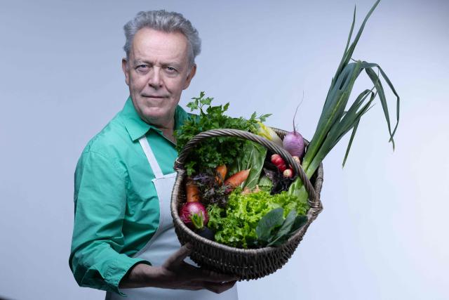 Michelin-starred French chef Alain Passard, known for his exclusively vegetable-based cuisine, poses with vegetables from his garden, during a photo session in Paris on March 6, 2026. (Photo by Joel Saget / AFP)