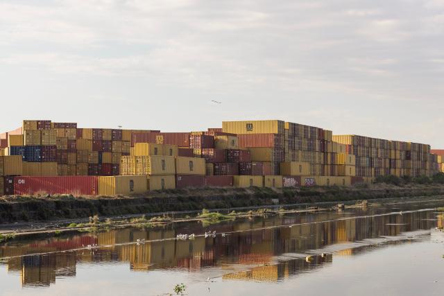 A general view of containers stacked up in the proximity of the Cape Town Harbour on March 11, 2026. (Photo by GIANLUIGI GUERCIA / AFP)