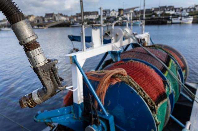 This photograph shows the head of a gas oil pipe in the port of Le Guilvinec, northwestern France, on March 11, 2025. Diesel fuel ‘has reached a price that is quite critical for us,’ protests net fisherman David Le Quintrec, as he unloads sole and sea bass caught overnight at the port of Lorient on March 11, 2026, while the industry calls for emergency measures. (Photo by Fred TANNEAU / AFP)