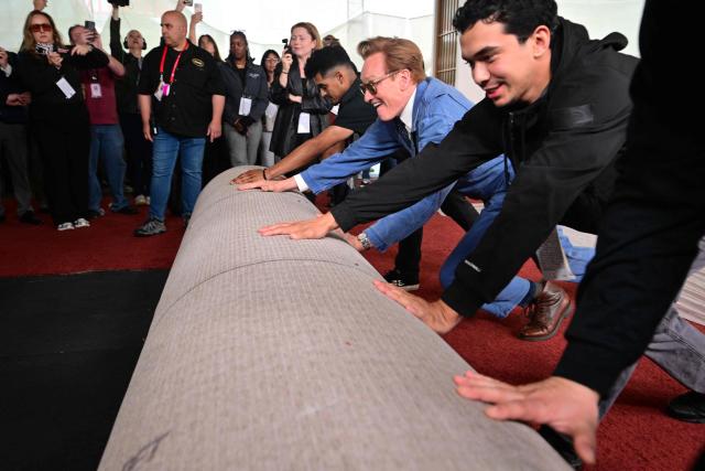 Host Conan O'Brien (C) participates in the 98th Oscars arrivals carpet roll out at the Dolby Theatre at Ovation in Hollywood, California on March 11, 2026, ahead of the Academy Awards on March 15. (Photo by Frederic J. Brown / AFP)