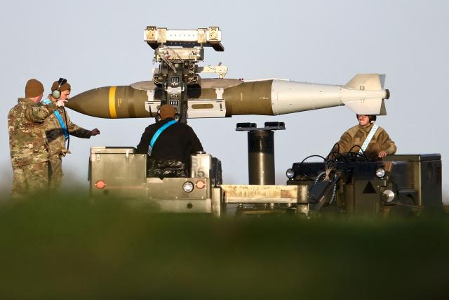 USAF military ground personnel load Joint Direct Attack Munitions (JDAM) into a US Air Force (USAF) B-1 Lancer bomber on the tarmac at RAF Fairford in south-west England on March 11, 2026. Fairford is one of two bases, along with the Diego Garcia facility in the Indian Ocean, that the UK has given the US permission to use for "specific defensive operations into Iran" to destroy Iranian missiles at source, the British defence minister said in a statement. (Photo by Henry NICHOLLS / AFP)