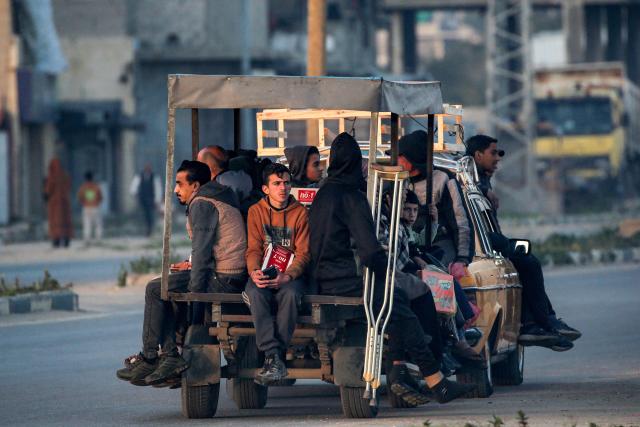 People ride in the back of a small truck used for transportation in Nuseirat in the central Gaza Strip on March 11, 2026. (Photo by Eyad Baba / AFP)