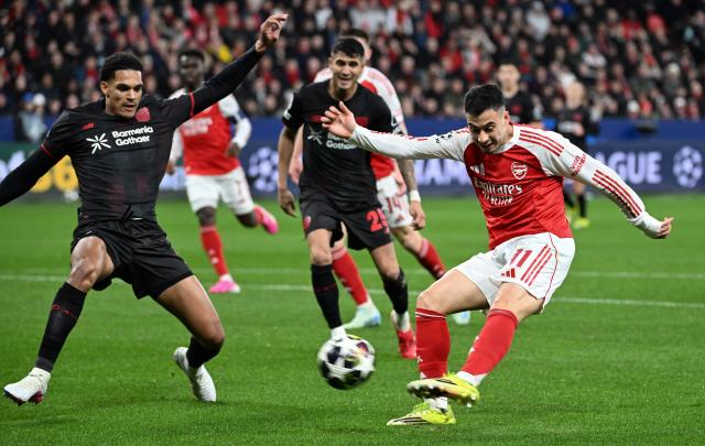 Arsenal's Brazilian midfielder #11 Gabriel Martinelli (R) kicks the ball during the UEFA Champions League, Last 16, first-leg football match Bayer 04 Leverkusen vs Arsenal in Leverkusen, western Germany, on March 11, 2026. (Photo by UWE KRAFT / AFP)