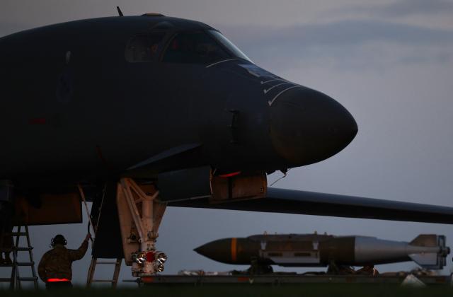 TOPSHOT - USAF military ground personnel load Joint Direct Attack Munitions (JDAM) into a US Air Force (USAF) B-1 Lancer bomber on the tarmac at RAF Fairford in south-west England on March 11, 2026. Fairford is one of two bases, along with the Diego Garcia facility in the Indian Ocean, that the UK has given the US permission to use for "specific defensive operations into Iran" to destroy Iranian missiles at source, the British defence minister said in a statement. (Photo by Henry NICHOLLS / AFP)