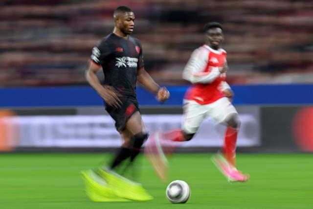 Bayer Leverkusen's Cameroonian forward #35 Christian Kofane (L) and Arsenal's English midfielder #07 Bukayo Saka vie for the ball during the UEFA Champions League, Last 16, first-leg football match Bayer 04 Leverkusen vs Arsenal in Leverkusen, western Germany, on March 11, 2026. (Photo by INA FASSBENDER / AFP)