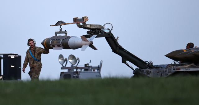 USAF military ground personnel load Joint Direct Attack Munitions (JDAM) into a US Air Force (USAF) B-1 Lancer bomber on the tarmac at RAF Fairford in south-west England on March 11, 2026. Fairford is one of two bases, along with the Diego Garcia facility in the Indian Ocean, that the UK has given the US permission to use for "specific defensive operations into Iran" to destroy Iranian missiles at source, the British defence minister said in a statement. (Photo by Henry NICHOLLS / AFP)