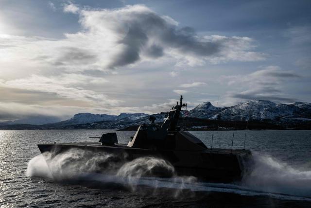 A Skjold-class Corvette of the Norwegian Navy manoeuvres off the coast of Harstad on March 11, 2026, as NATO conducts its Cold Response military exercise. The Norwegian-led winter exercise involves 32.000 troops, 100 aircraft, and 30 warships from 14 nations taking part in high intensity, multi-domain operations in an arctic climate. (Photo by John MACDOUGALL / AFP)