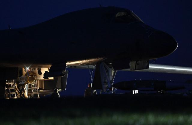 USAF military ground personnel load Joint Direct Attack Munitions (JDAM) into a US Air Force (USAF) B-1 Lancer bomber on the tarmac at RAF Fairford in south-west England on March 11, 2026. Fairford is one of two bases, along with the Diego Garcia facility in the Indian Ocean, that the UK has given the US permission to use for "specific defensive operations into Iran" to destroy Iranian missiles at source, the British defence minister said in a statement. (Photo by Henry NICHOLLS / AFP)