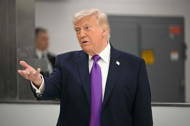 US President Donald Trump tours Thermo Fisher Scientific laboratories in Cincinnati, Ohio, on March 11, 2026. Trump is meeting with Thermo Fisher officials to discuss prescription drug prices. (Photo by Jim WATSON / AFP)