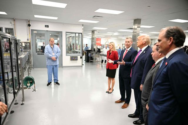US President Donald Trump tours Thermo Fisher Scientific laboratories in Cincinnati, Ohio, on March 11, 2026. Trump is meeting with Thermo Fisher officials to discuss prescription drug prices. (Photo by Jim WATSON / AFP)