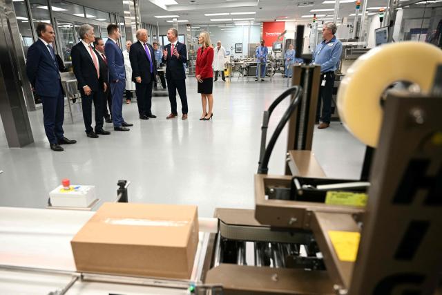 US President Donald Trump tours Thermo Fisher Scientific laboratories in Cincinnati, Ohio, on March 11, 2026. Trump is meeting with Thermo Fisher officials to discuss prescription drug prices. (Photo by Jim WATSON / AFP)