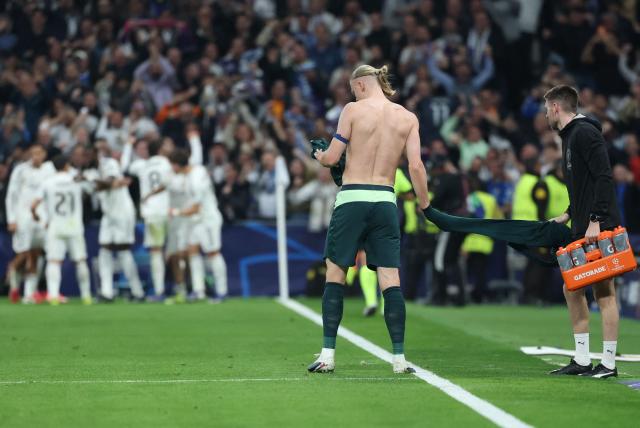 Manchester City's Norwegian forward #09 Erling Haaland changes his jersey during the UEFA Champions League last 16 first leg football match between Real Madrid CF and Manchester City at Santiago Bernabeu Stadium in Madrid on March 11, 2026. (Photo by Thomas COEX / AFP)