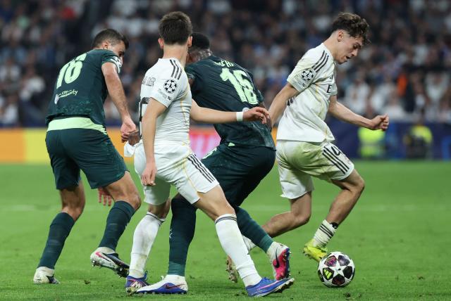 Manchester City's Spanish midfielder #16 Rodri, Real Madrid's Turkish midfielder #15 Arda Guler (2L), Manchester City's English defender #15 Marc Guehi and Real Madrid's Spanish midfielder #45 Thiago Pitarch (R) fight for the ball during the UEFA Champions League last 16 first leg football match between Real Madrid CF and Manchester City at Santiago Bernabeu Stadium in Madrid on March 11, 2026. (Photo by Thomas COEX / AFP)