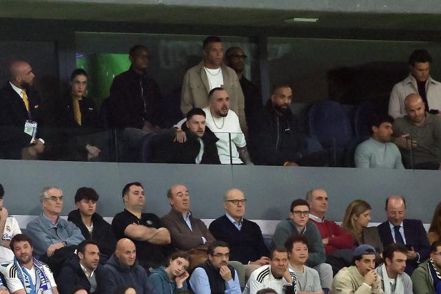 Real Madrid's French forward #10 Kylian Mbappe (TOP C) watches the match from the stands during the UEFA Champions League last 16 first leg football match between Real Madrid CF and Manchester City at Santiago Bernabeu Stadium in Madrid on March 11, 2026. (Photo by Thomas COEX / AFP)