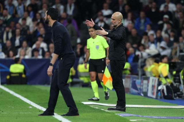 Manchester City's Spanish coach Pep Guardiola (R) gestures during the UEFA Champions League last 16 first leg football match between Real Madrid CF and Manchester City at Santiago Bernabeu Stadium in Madrid on March 11, 2026. (Photo by Thomas COEX / AFP)