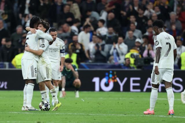 Real Madrid players react at the end of the UEFA Champions League last 16 first leg football match between Real Madrid CF and Manchester City at Santiago Bernabeu Stadium in Madrid on March 11, 2026. Real madrid won 3-0. (Photo by Thomas COEX / AFP)