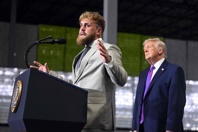 US boxer and influencer Jake Paul speaks as US President Donald Trump looks on during a rally at Verst Logistics in Hebron, Kentucky, on March 11, 2026. (Photo by Jim WATSON / AFP)