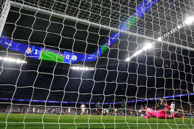 Manchester City's Italian goalkeeper #25 Gianluigi Donnarumma concedes the second goal shot by Real Madrid's Uruguayan midfielder #08 Federico Valverde (R) during the UEFA Champions League last 16 first leg football match between Real Madrid CF and Manchester City at Santiago Bernabeu Stadium in Madrid on March 11, 2026. Real Madrid won 3-0. (Photo by Pierre-Philippe MARCOU / AFP)