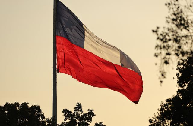 A Chilean flag waves after the inauguration of Chile's new President Jose Antonio Kast outside La Moneda palace in Santiago on March 11, 2026. Chile's most right-wing president in over three decades, Jose Antonio Kast, takes office on March 11, 2026, on a promise to tackle surging rates of violent crime and carry out mass migrant deportations. (Photo by Javier TORRES / AFP)