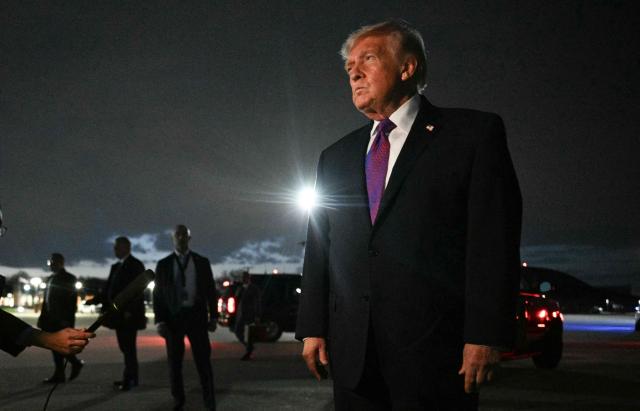 US President Donald Trump speaks to journalists upon returning to Joint Base Andrews, Maryland on March 11, 2026. Trump is returning to the White House following a visit to Kentucky and Ohio. (Photo by Jim WATSON / AFP)