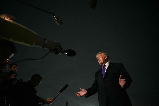 US President Donald Trump speaks to journalists upon returning to Joint Base Andrews, Maryland on March 11, 2026. Trump is returning to the White House following a visit to Kentucky and Ohio. (Photo by Jim WATSON / AFP)